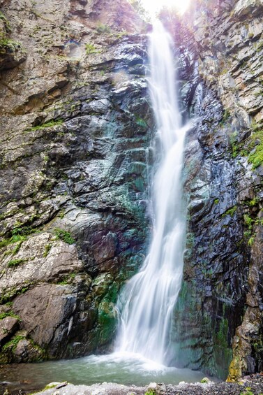 A waterfall cascading down a rocky cliff. 3