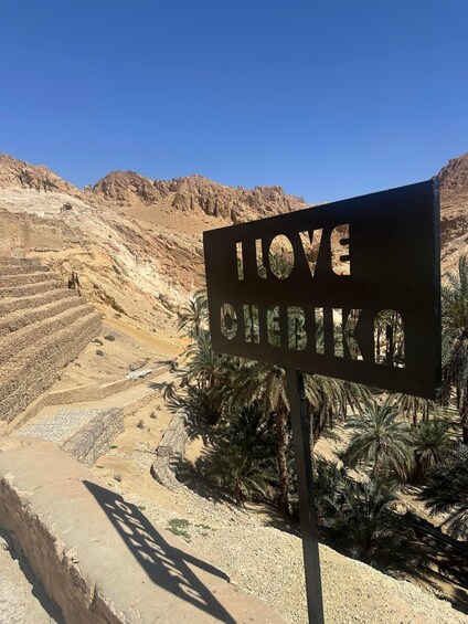 A desert landscape with a sign that reads 'I LOVE SENERIKA.' 3