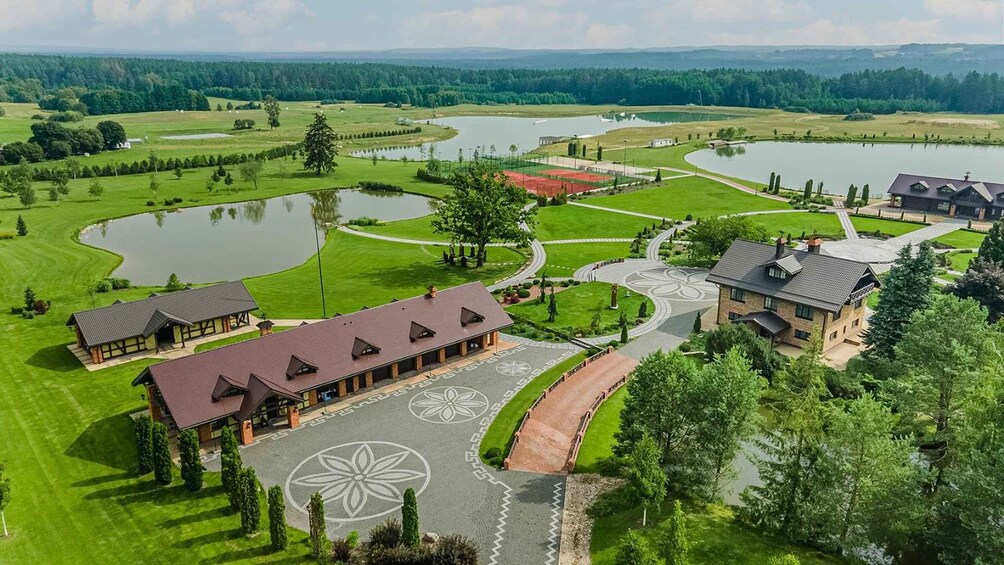 A golf course with multiple ponds, a clubhouse, and surrounding greenery. 3