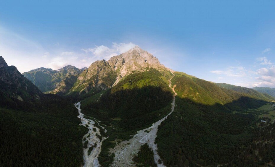 A mountain range with a river flowing through a valley. 4