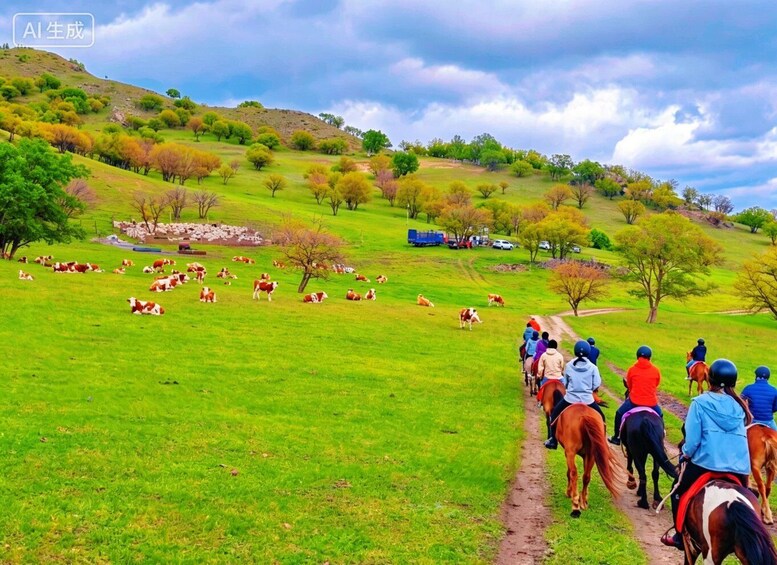 A group of people riding horses along a path through a grassy field with cows grazing in the distance. 2