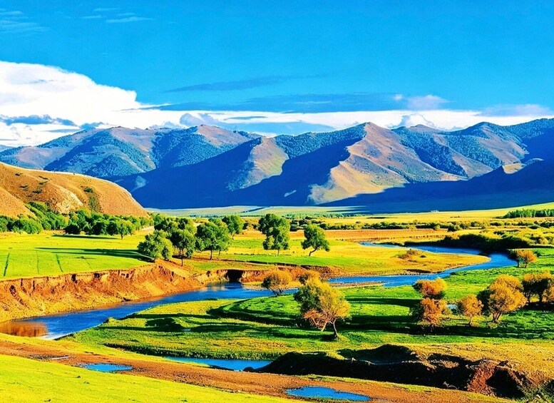 A river winding through terraced fields with mountains in the background. 4