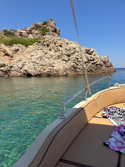 A boat with a rocky island in the background. 1