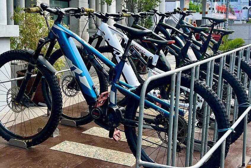 A row of bicycles parked in a metal rack. 1