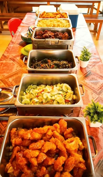 A buffet table with various food dishes in metal containers. 3