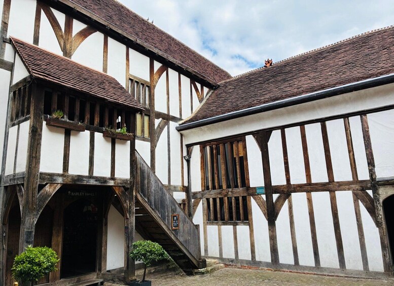A traditional half-timbered building with a staircase leading to an entrance. 2