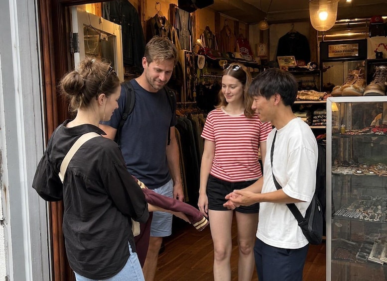 A group of people inside a store with various items on display. 3