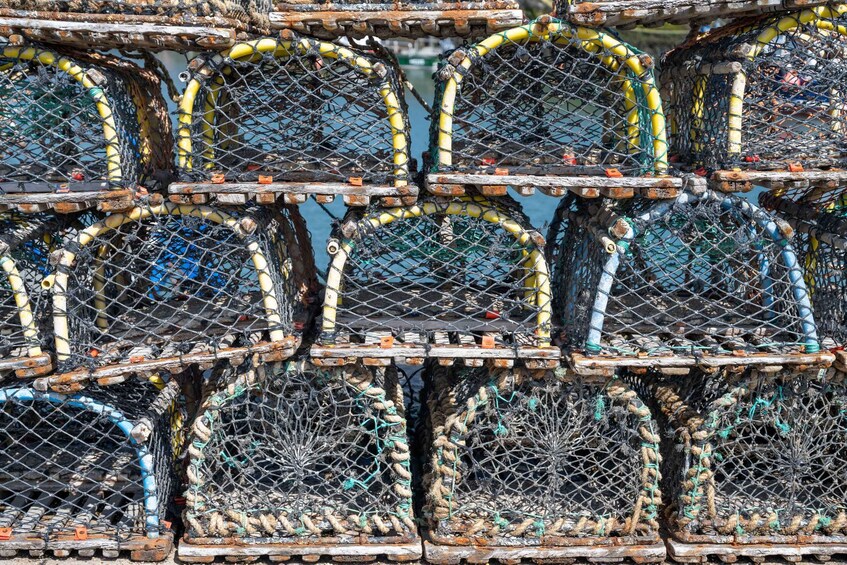 A collection of lobster traps stacked together. 5