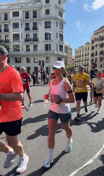 A group of people running in a city street with historic buildings in the background. 2