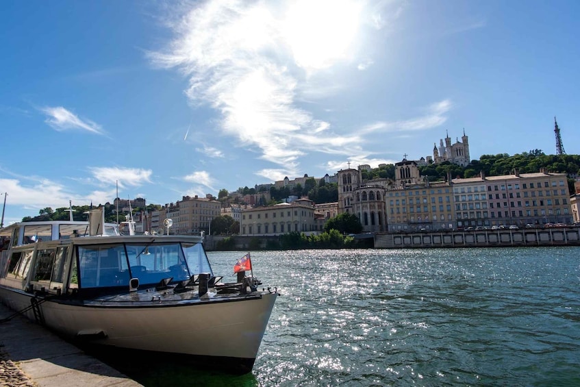 A boat docked at a harbor with a historic building in the background. 1