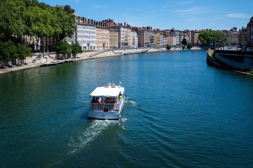 A river with a boat named 'Lui' and buildings along the riverbank. 3