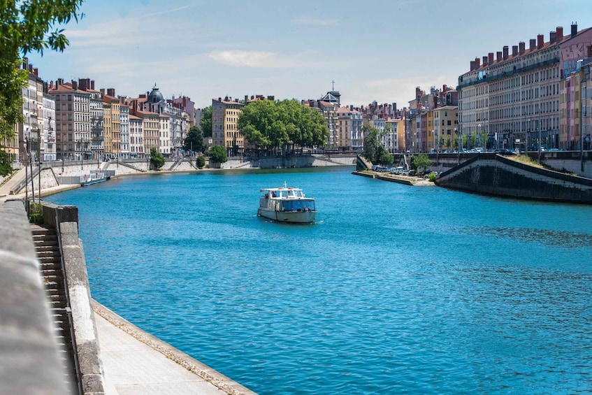 A river with a boat, surrounded by historic buildings and a bridge. 4