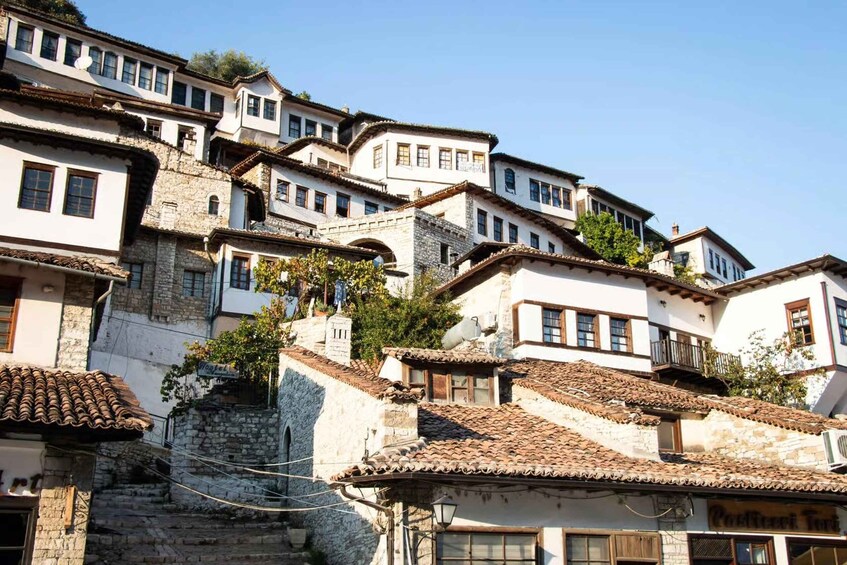 A hillside village with terraced buildings, stone walls, and traditional tiled roofs. 5