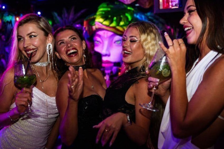 A group of people at a party with drinks. 4