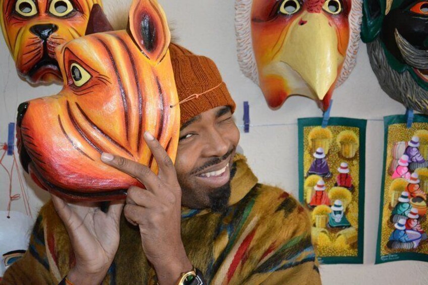 A person holding a colorful mask with a tiger design. 5