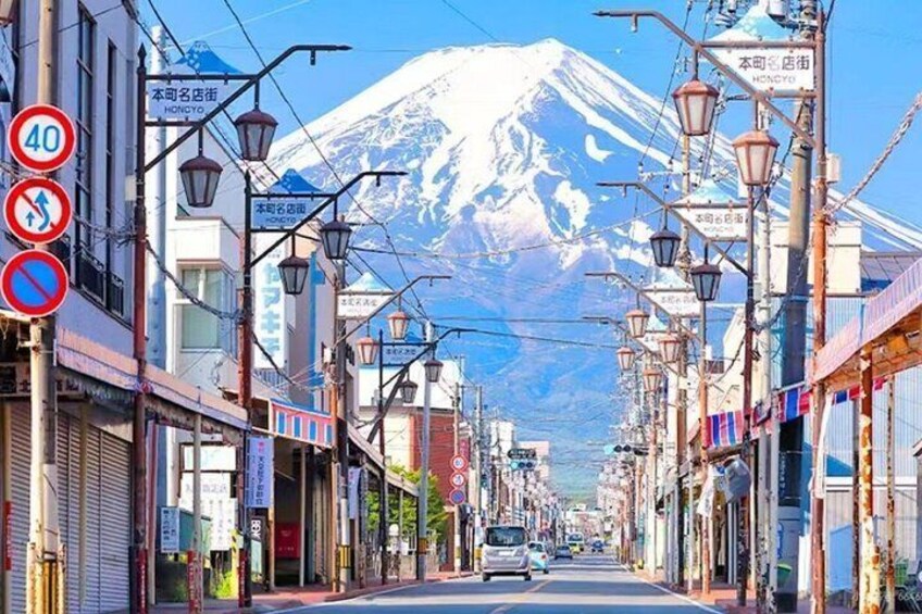 A street with shops, a mountain in the background, and a speed limit sign of 40. 1