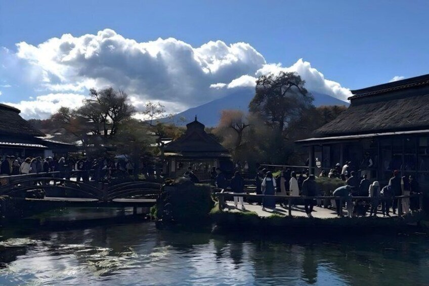 A traditional Japanese garden with a pond, bridges, and pagodas. 3