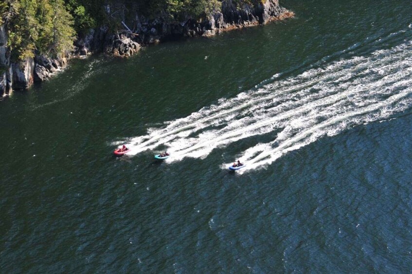 A river with three boats creating wake patterns. 4