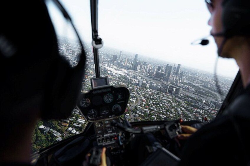 A helicopter cockpit with a cityscape view. 2
