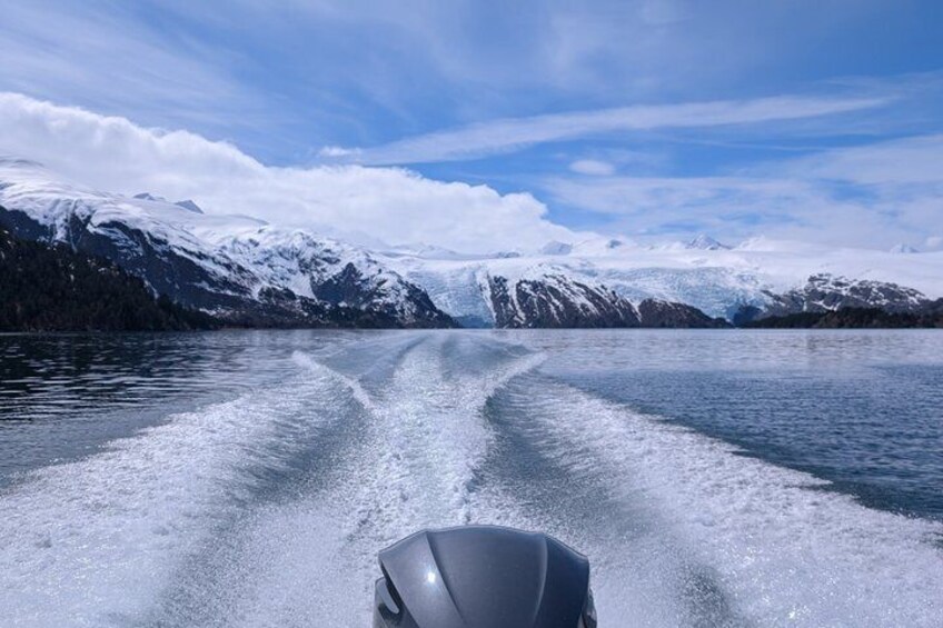 A boat on a frozen lake with snow-covered mountains in the background. 4
