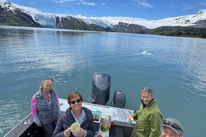 A group of people on a boat with a glacier in the background. 5