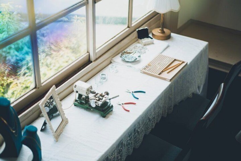 A table with crafting materials and a sewing machine. 3