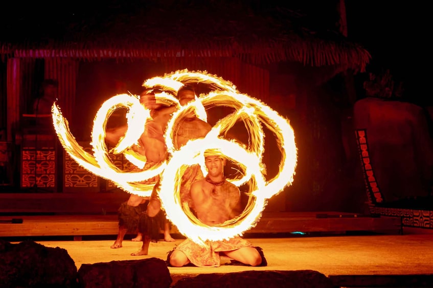 A person performing fire spinning with a large fire hoop. 4