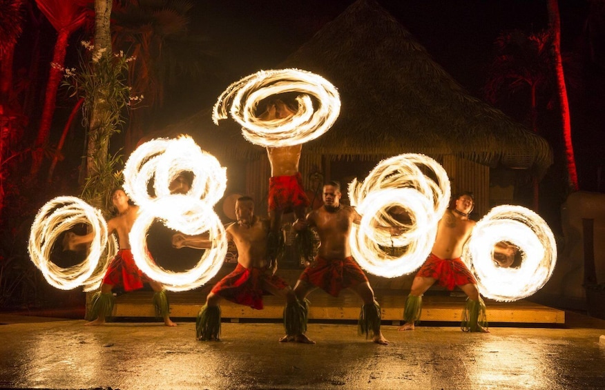 A fire performance with performers creating large fire rings. 5