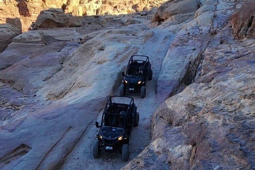 Three off-road vehicles on a rocky trail. 3