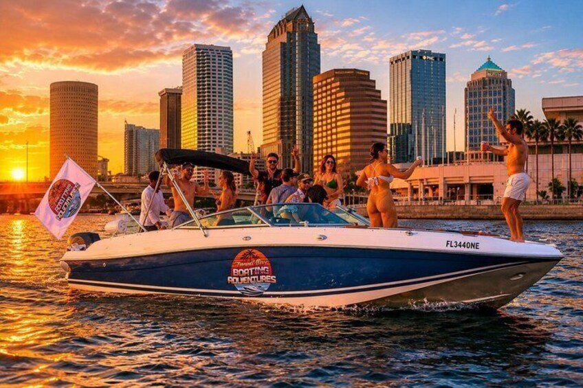 A boat with people on it, a city skyline in the background, and a sunset. 1