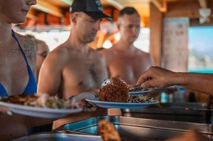 People serving food at a buffet. 2
