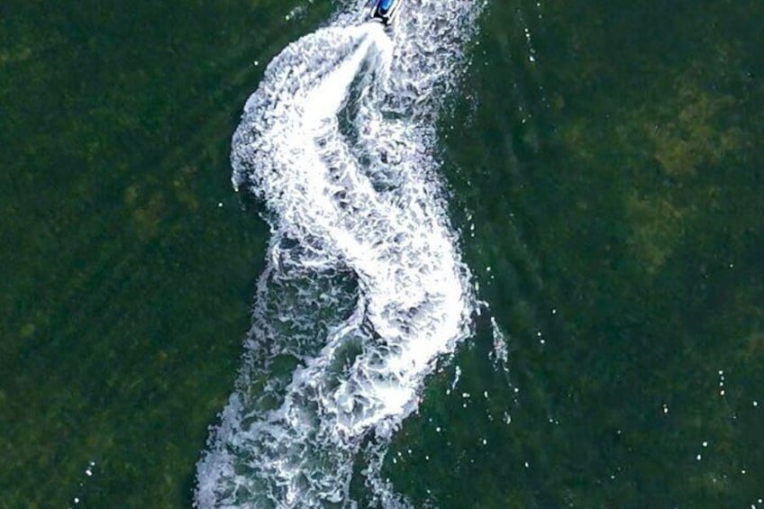 A large body of water with a wake created by a moving object, possibly a boat or ship. 2