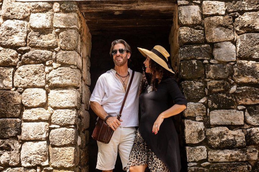 A stone doorway with two people standing inside. 4
