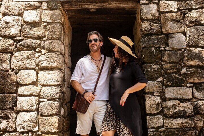 A stone doorway with two people standing inside. 4