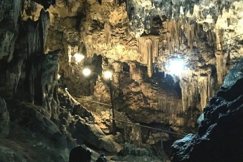 A cave with stalactites and a rope bridge. 3