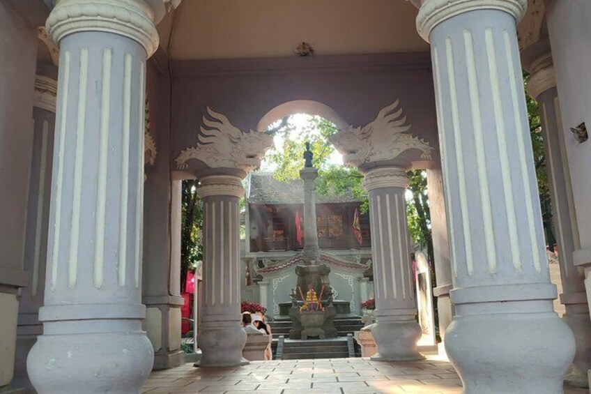 A classical architectural structure with columns and a central fountain. 3