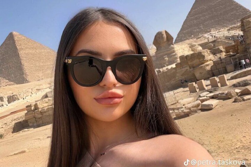 A person in front of the Great Pyramid of Giza. 5