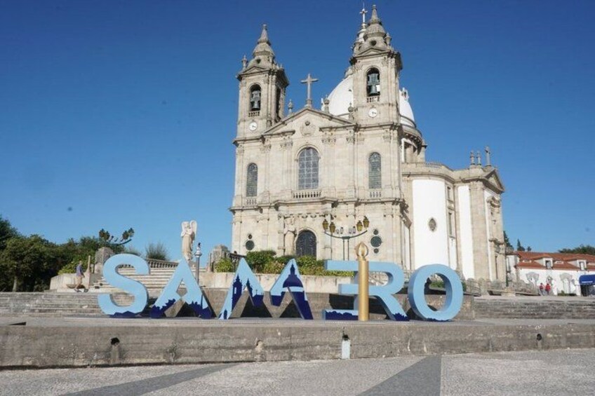 A church with two towers and a large 'SAMARU' sign in front. 4
