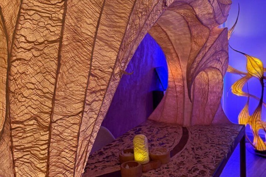 A cave-like structure with textured walls and a central platform. 4