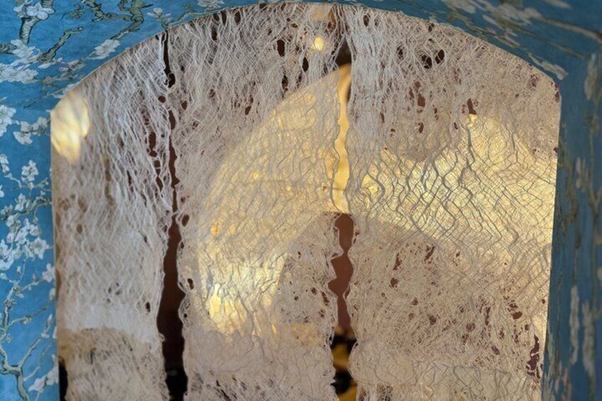 A close-up of a textured surface with intricate patterns and a reflective sheen. 5
