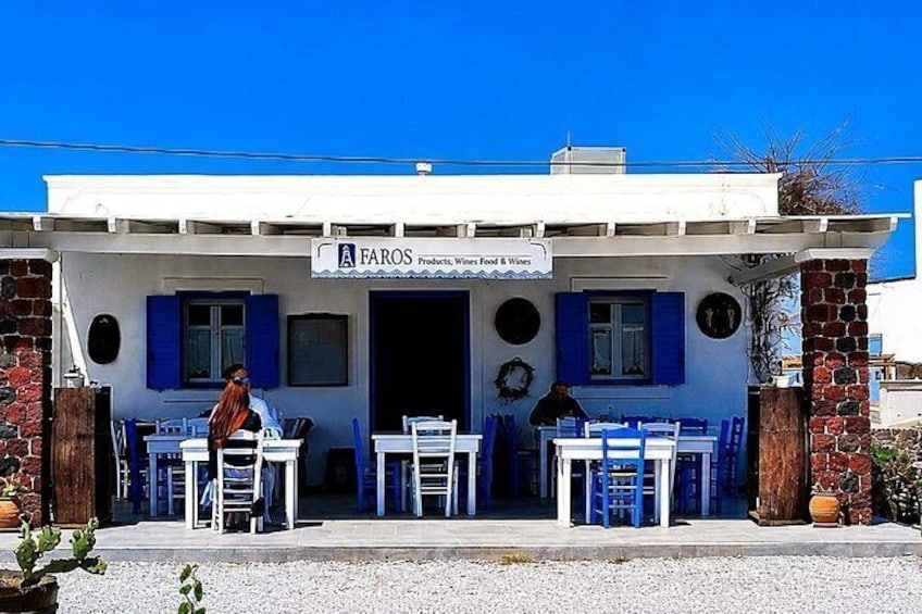 A restaurant named 'A FAROS' with outdoor seating and a blue and white color scheme. 3
