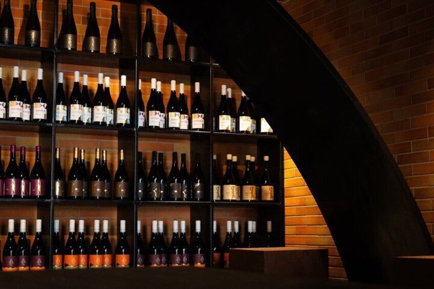 A wine cellar with shelves of bottles. 3