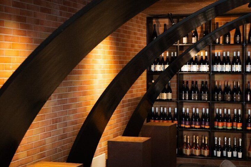 A brick wall with a wooden staircase and a wine rack. 4