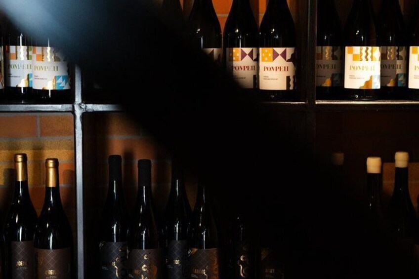 A wine rack with bottles labeled 'POPEII' and 'POPEII 2017.' 2