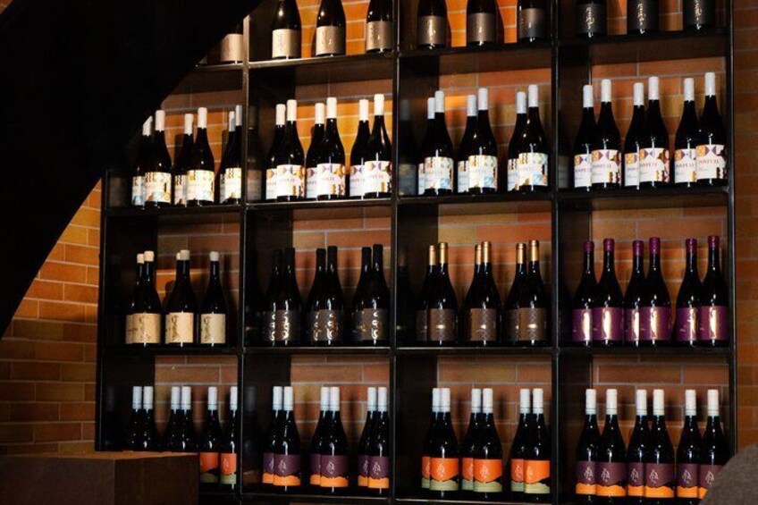 A wine rack with various bottles. 5