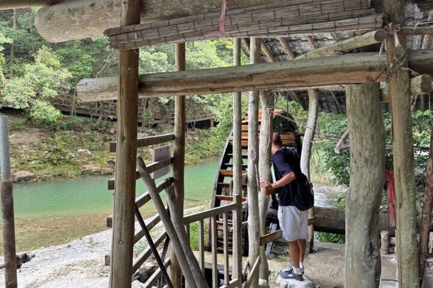 A wooden bridge structure with a person climbing a ladder. 5