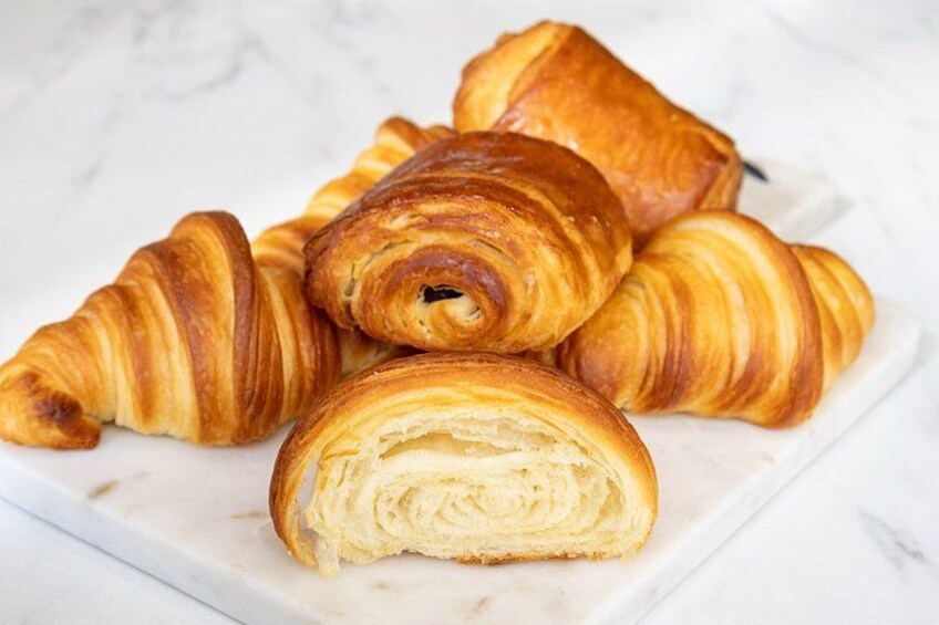 A plate of croissants on a marble surface. 1
