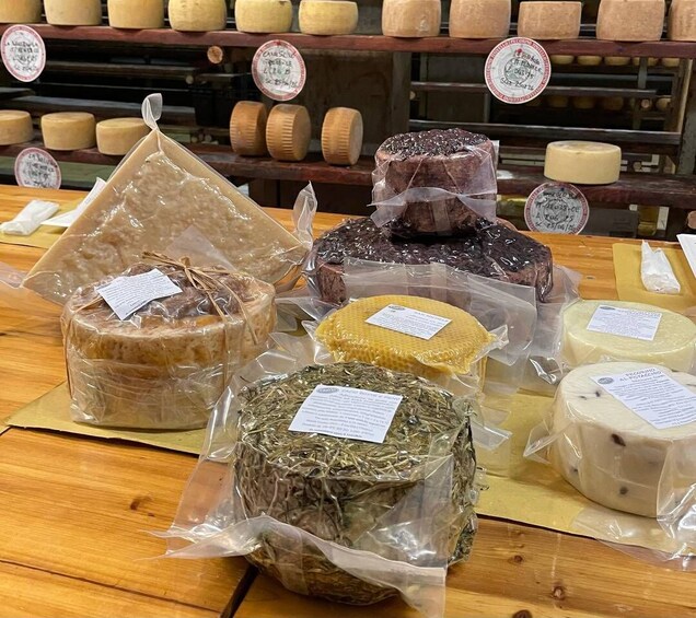 Various cheeses on display in a shop. 4