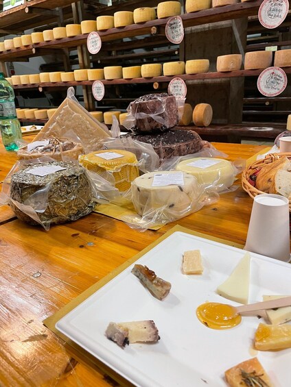 A variety of cheeses on display in a shop. 2