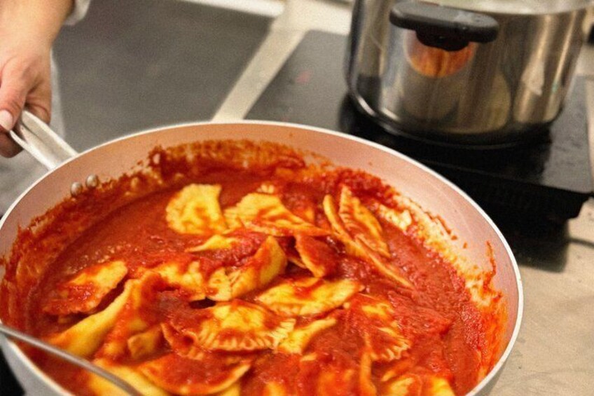 A pot of ravioli in tomato sauce. 1